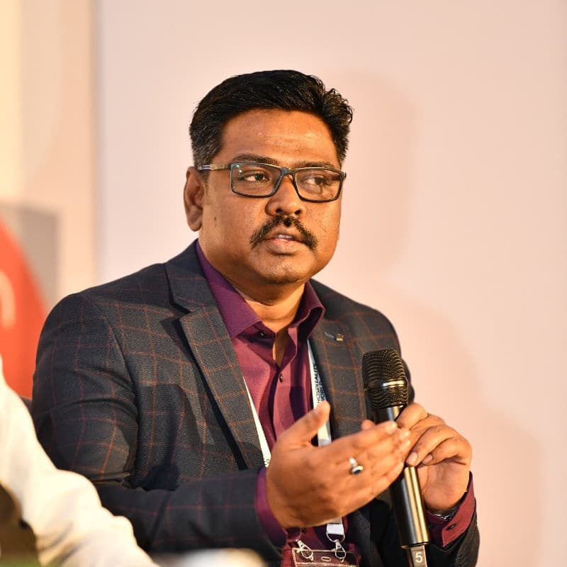 Raj Sahu, Founder and CEO of NISKA, speaking on stage with a microphone